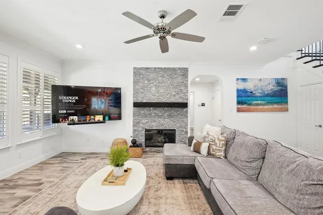 a living room with furniture a fireplace and a flat screen tv