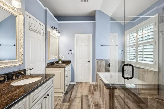 a spacious bathroom with a granite countertop sink and a mirror