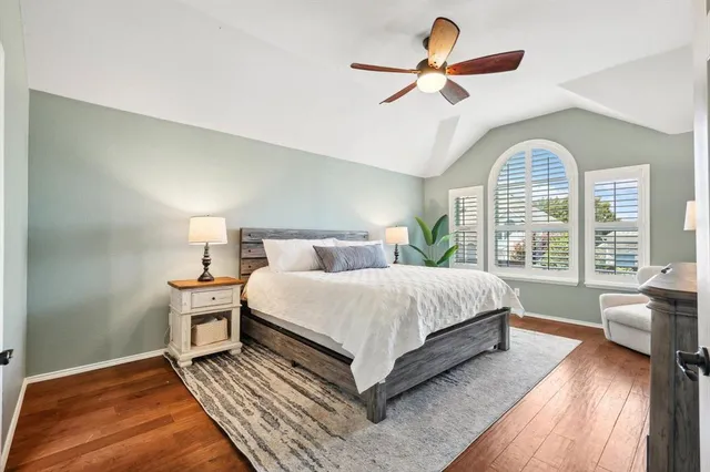 a bedroom with a large bed and a chandelier