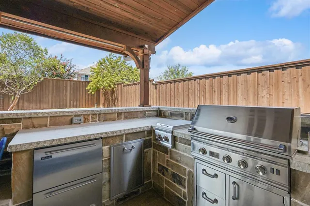 a kitchen with a stove and a white wooden cabinets