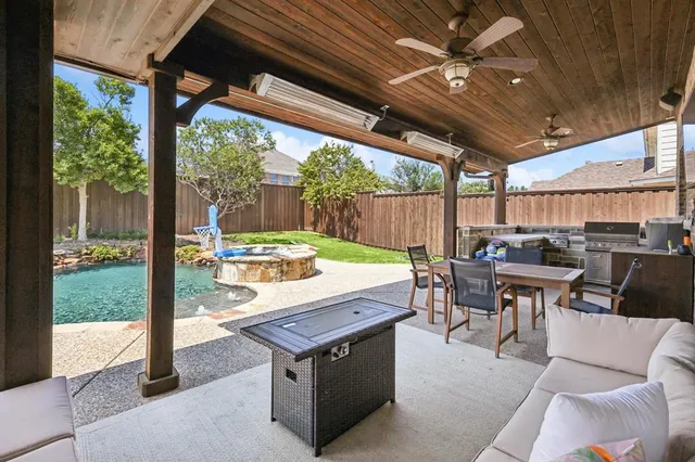 a view of a patio with a table chairs and a backyard