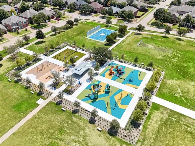 a view of swimming pool with a yard and plants