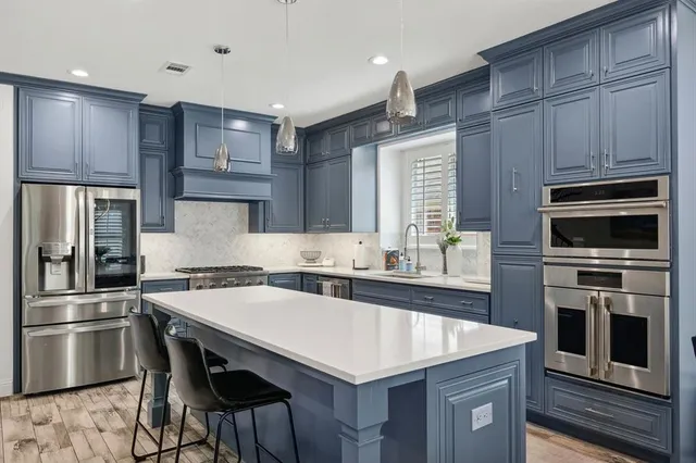 a kitchen with a stove a sink and a refrigerator