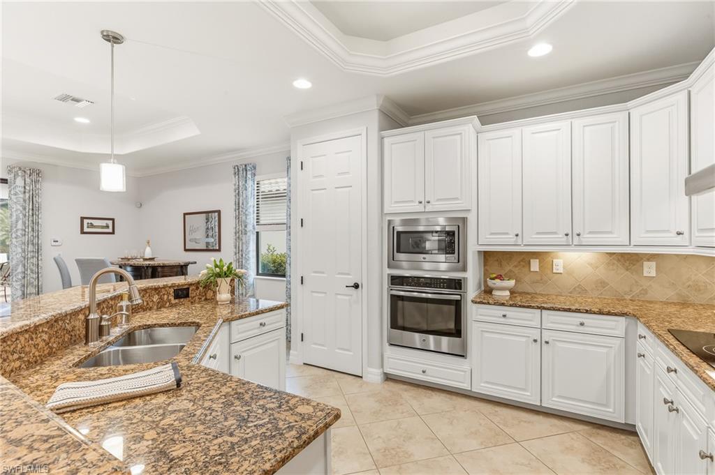 12614 Fenhurst Way Naples, FL 34120 - Photo 8 of 44 So much storage, pull out drawers in kitchen cabinetry