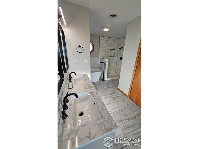a bathroom with a sink bathtub and shower