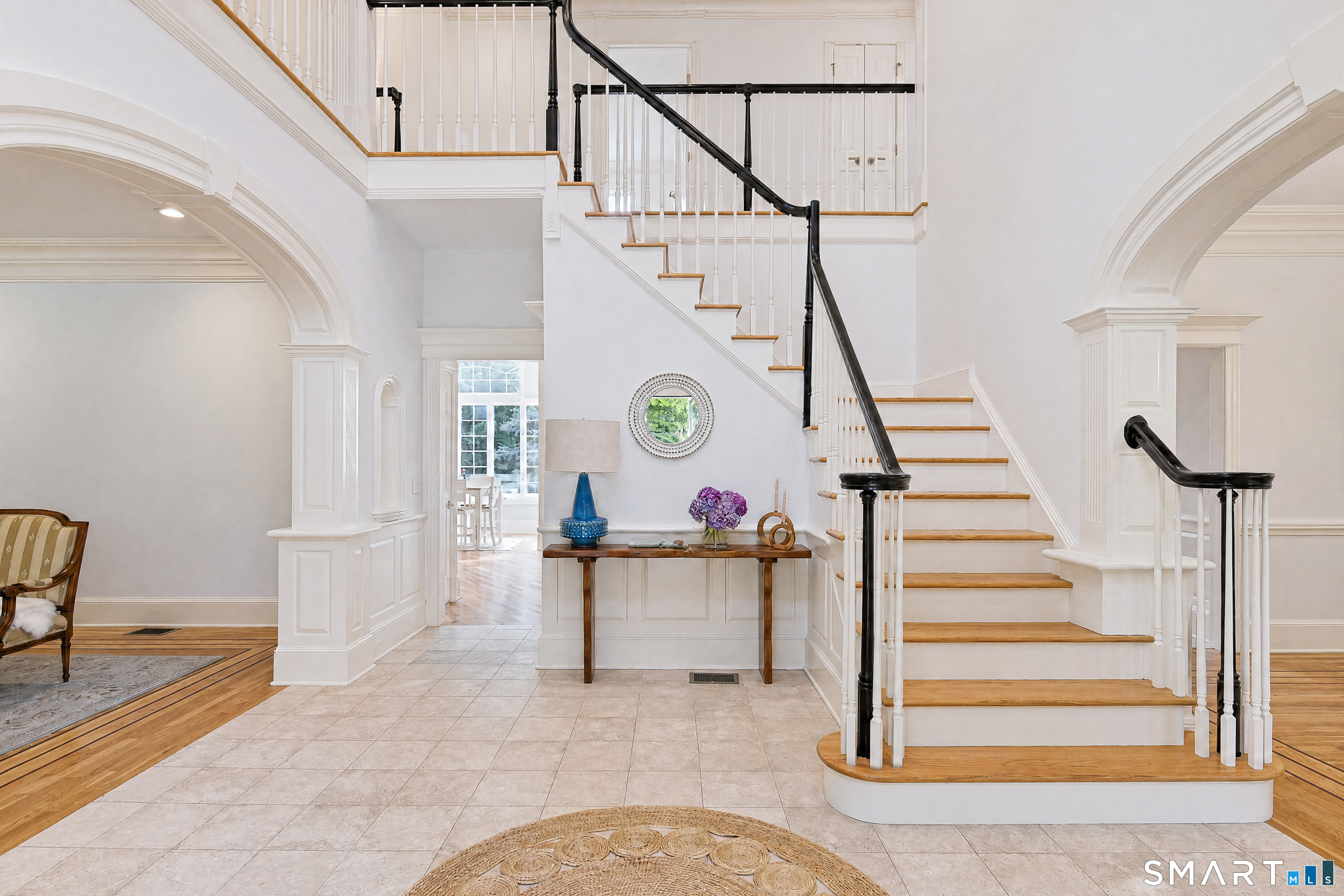 17 Kent Road Newtown, CT 06470 - Photo 2 of 40 Bright two-story foyer with a curved staircase and hardwood details.