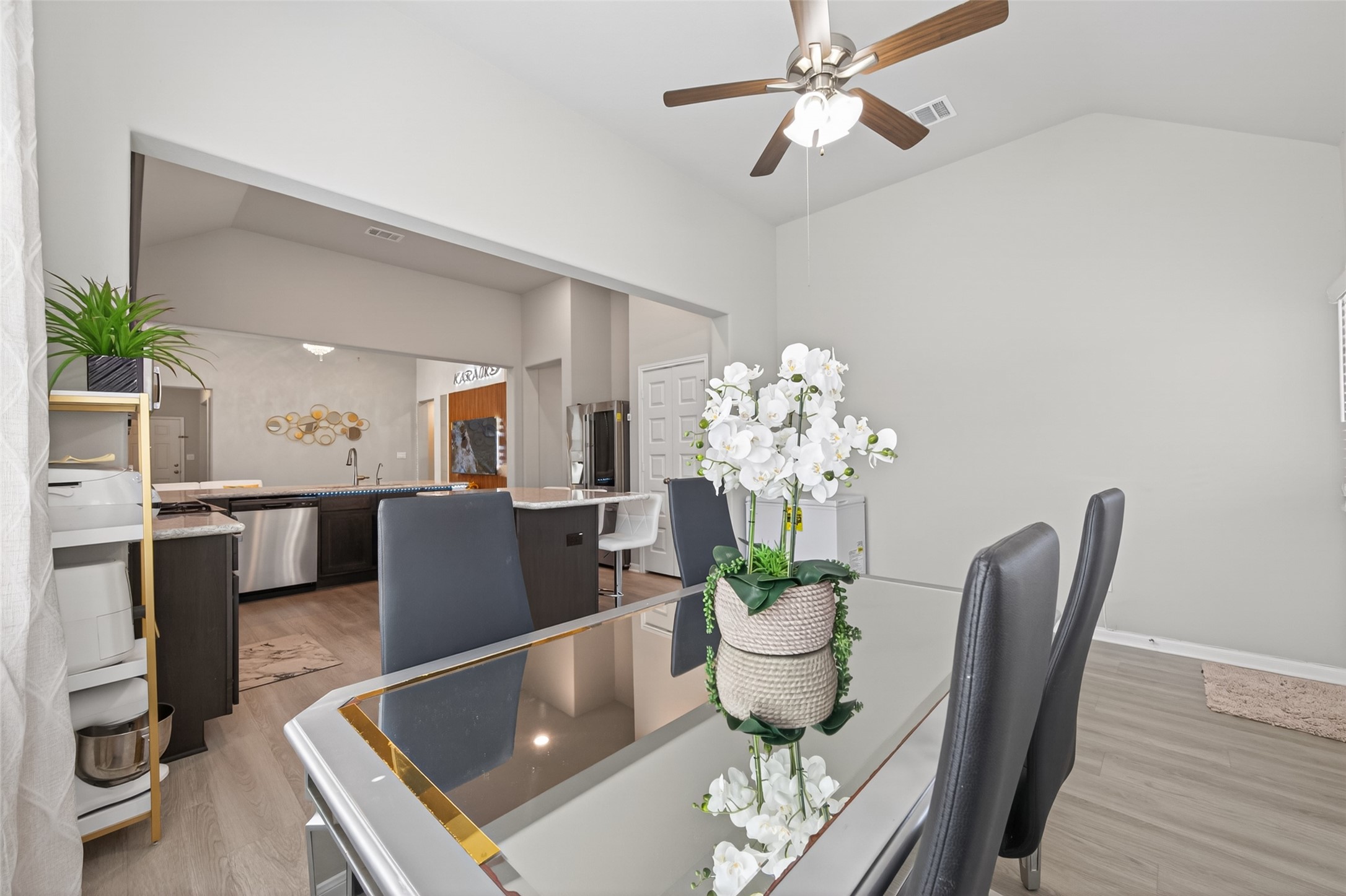 22409 Kinley Street New Caney, TX 77357 - Photo 24 of 46 a dining room with furniture a chandelier and wooden floor