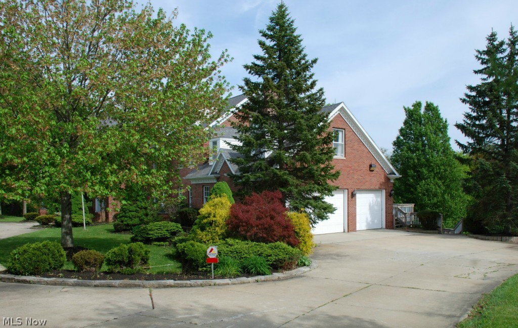 2890 Roundhill Road Akron, OH 44333 - Photo 23 of 25 SIDE VIEW OF HOME, 3 CAR SIDE LOAD HEATED GARAGE, ADDITIONAL 2+ GARAGE TUCKED BEHIND HOME
