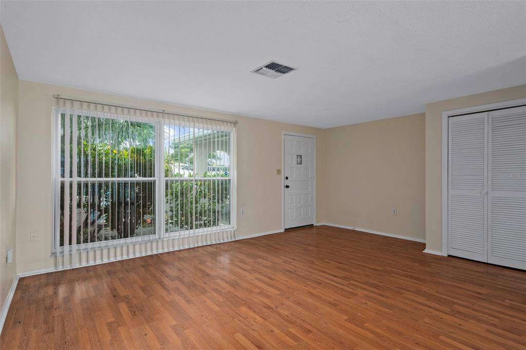 7403 Populus Drive Port Richey, FL 34668 - Photo 11 of 50 a view of an empty room with wooden floor and a window