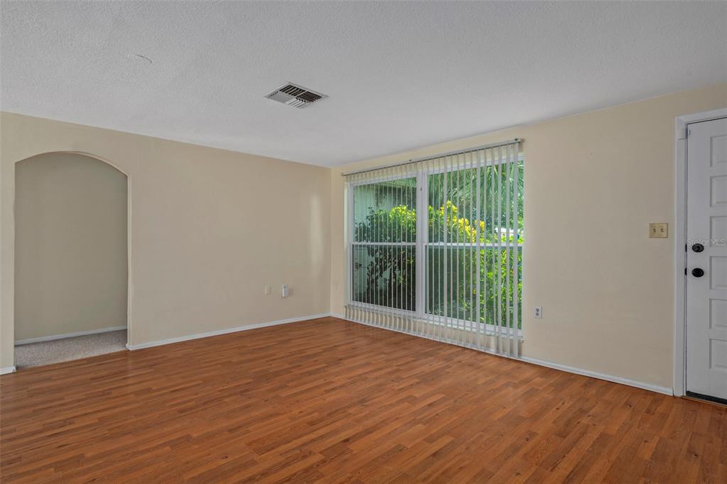 7403 Populus Drive Port Richey, FL 34668 - Photo 12 of 50 a view of an empty room with wooden floor and a window
