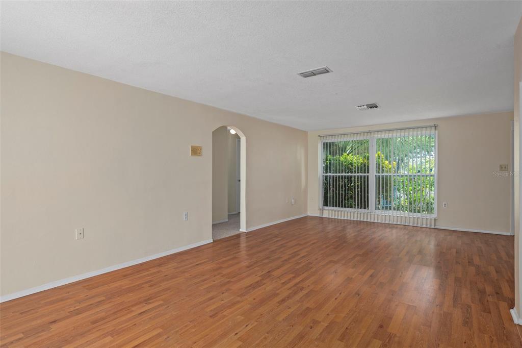 7403 Populus Drive Port Richey, FL 34668 - Photo 16 of 50 a view of an empty room with wooden floor and a window