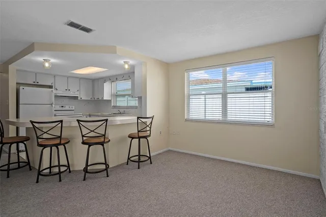 a view of a room with furniture and a window