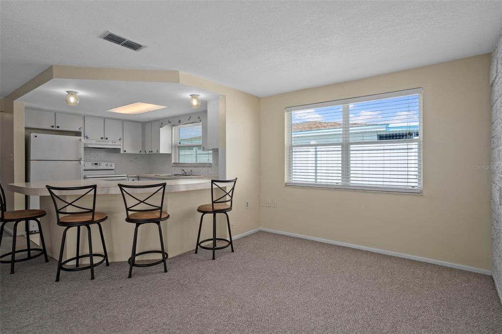 7403 Populus Drive Port Richey, FL 34668 - Photo 20 of 50 a kitchen with stainless steel appliances kitchen island granite countertop a stove a sink and a microwave