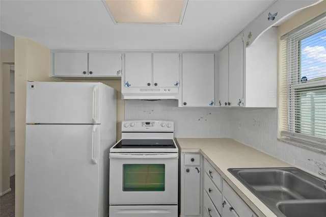 a view of a kitchen with center island and windows