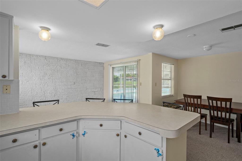 7403 Populus Drive Port Richey, FL 34668 - Photo 26 of 50 a view of a kitchen with center island and windows
