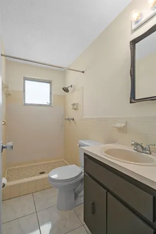 a view of a room with wooden floor and a window