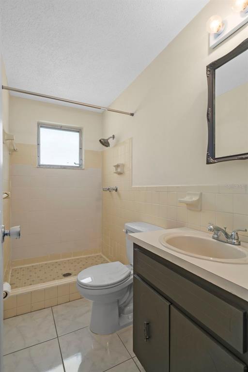 7403 Populus Drive Port Richey, FL 34668 - Photo 28 of 50 a bathroom with a sink a toilet and a mirror