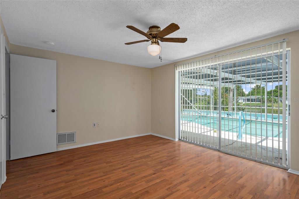 7403 Populus Drive Port Richey, FL 34668 - Photo 31 of 50 a view of an empty room with wooden floor and a window