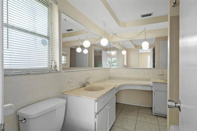 a bathroom with a tub a sink and mirror