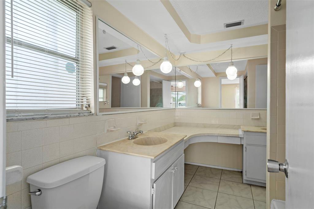 7403 Populus Drive Port Richey, FL 34668 - Photo 32 of 50 a bathroom with a toilet sink and mirror