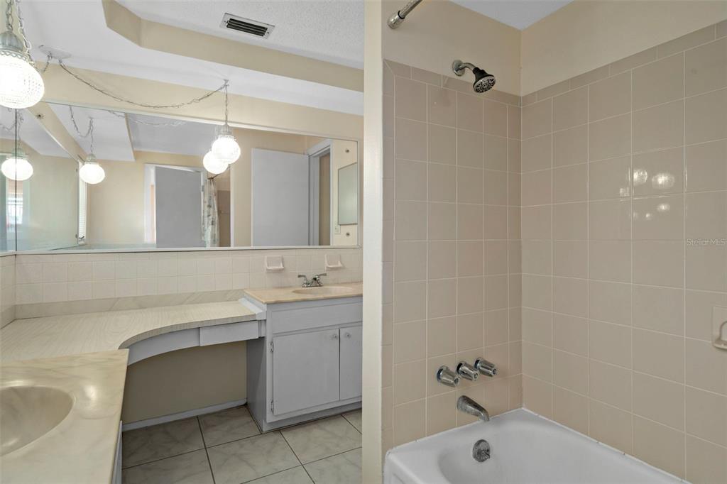 7403 Populus Drive Port Richey, FL 34668 - Photo 33 of 50 a bathroom with a tub a sink and mirror