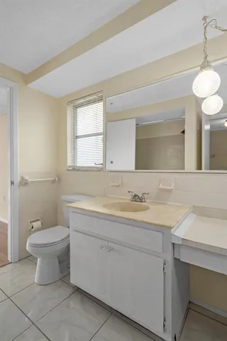 a bathroom with a sink a mirror a vanity and a bathtub