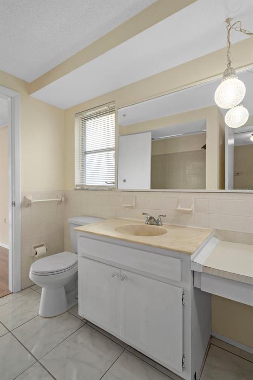 7403 Populus Drive Port Richey, FL 34668 - Photo 35 of 50 a bathroom with a toilet sink and mirror