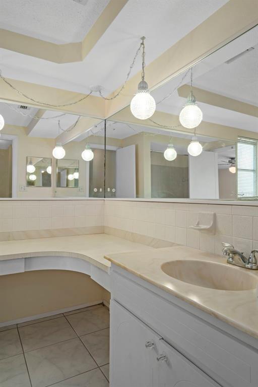 7403 Populus Drive Port Richey, FL 34668 - Photo 37 of 50 a bathroom with a sink a large mirror and a light fixture
