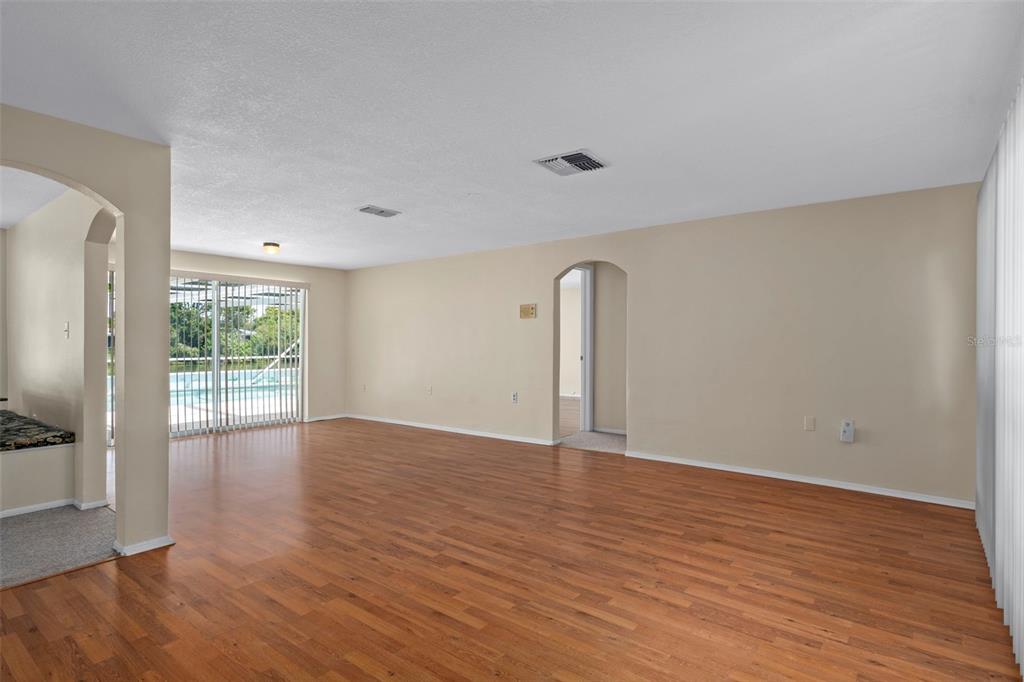 7403 Populus Drive Port Richey, FL 34668 - Photo 8 of 50 a view of an empty room with wooden floor and a window