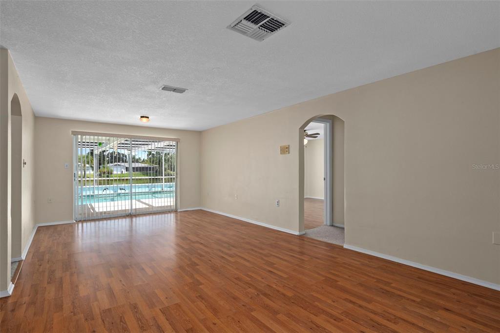 7403 Populus Drive Port Richey, FL 34668 - Photo 9 of 50 a view of an empty room with wooden floor and a window