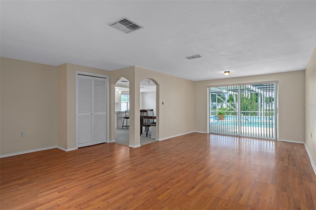 7403 Populus Drive Port Richey, FL 34668 - Photo 10 of 50 a view of empty room with wooden floor and fan