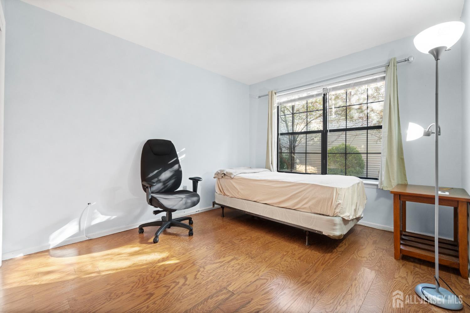 1002 Hidden Village Drive Perth Amboy, NJ 08861 - Photo 11 of 18 a bedroom with a bed chair and a large window