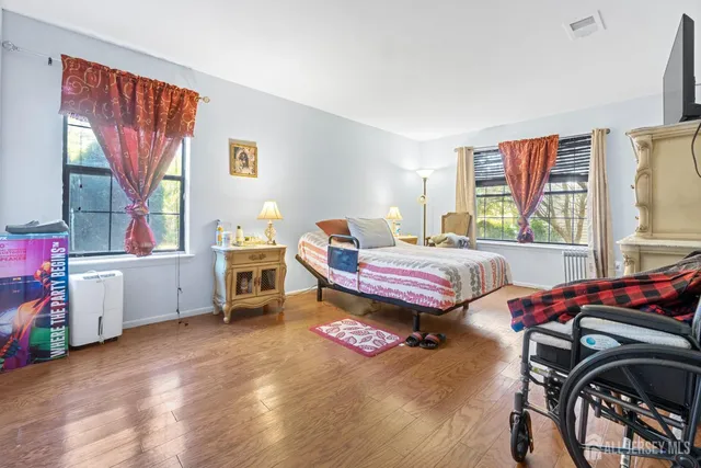 a bedroom with furniture and a window