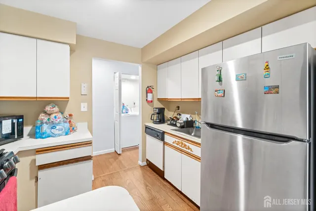 a kitchen with stainless steel appliances refrigerator and a cabinets