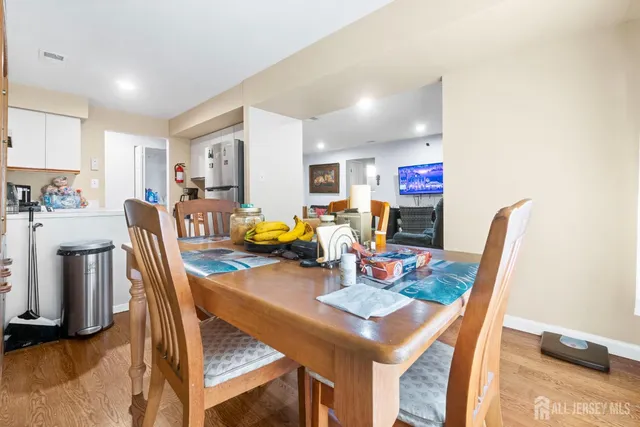 a dining room with furniture and a kitchen view