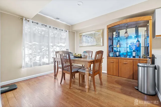 a dining room with furniture a window and wooden floor