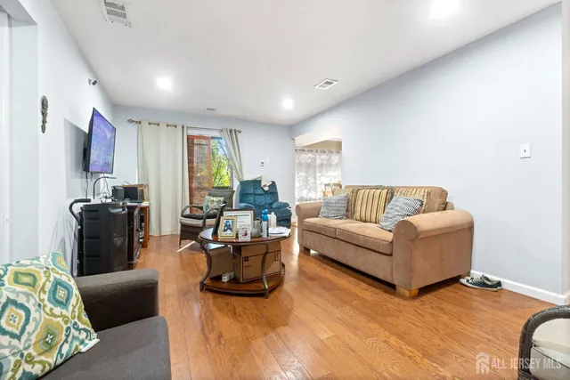 a living room with furniture window and a flat screen tv
