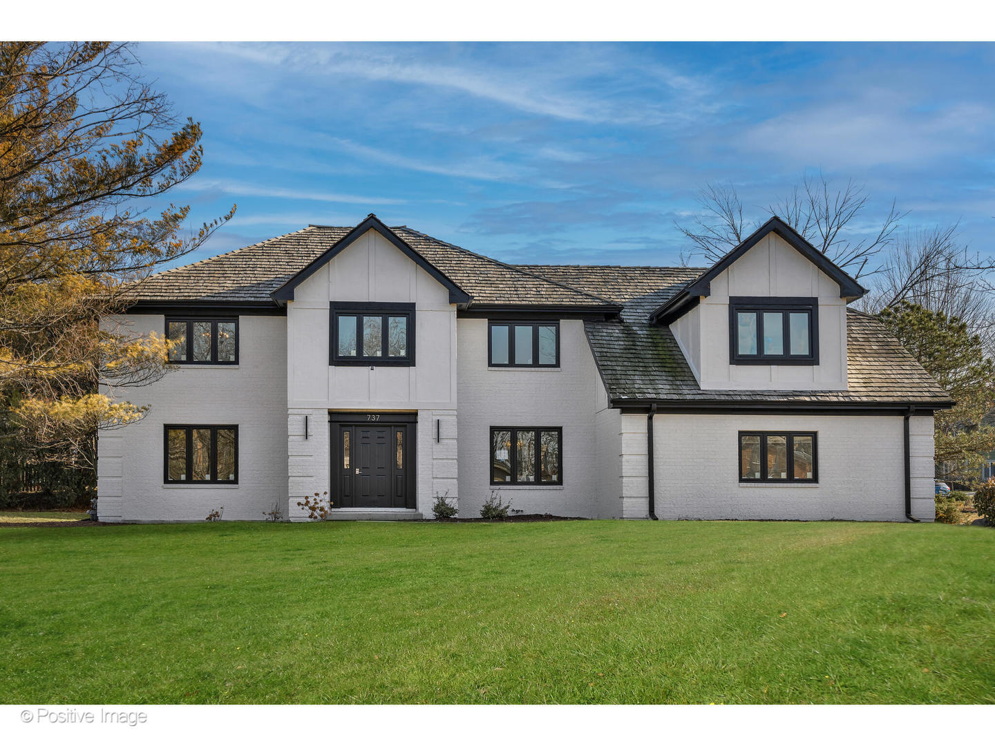 a big house with a big yard and large trees