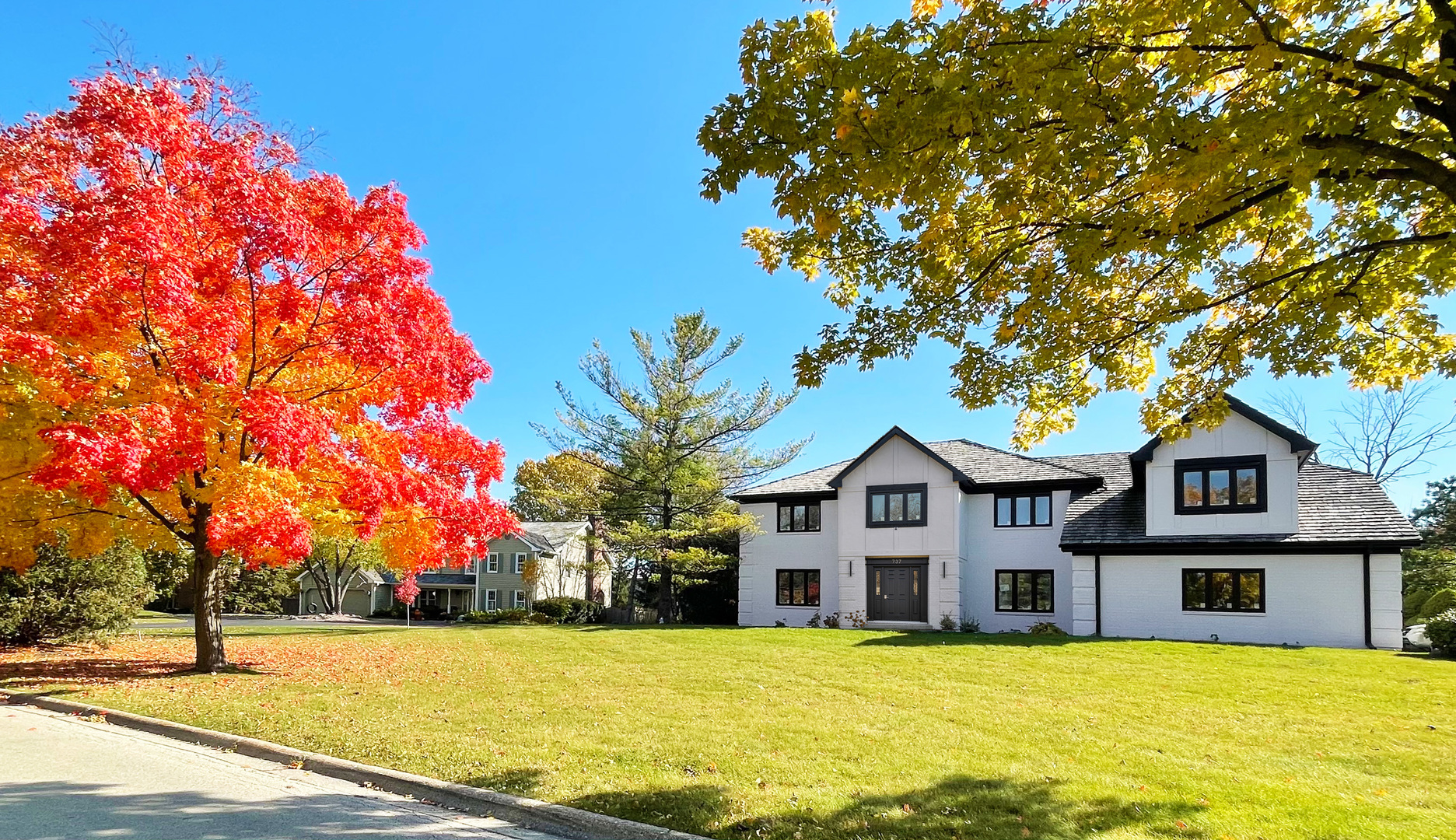 737 Valley Road Lake Forest, IL 60045 - Photo 2 of 17 a front view of a house with a yard and trees