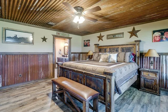 a bedroom with a bed and a chandelier