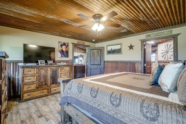 a bed room with furniture and a flat screen tv