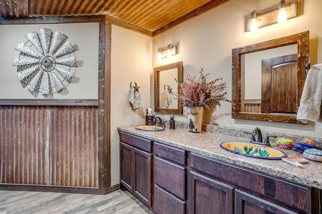 a bathroom with a granite countertop sink a mirror and vanity