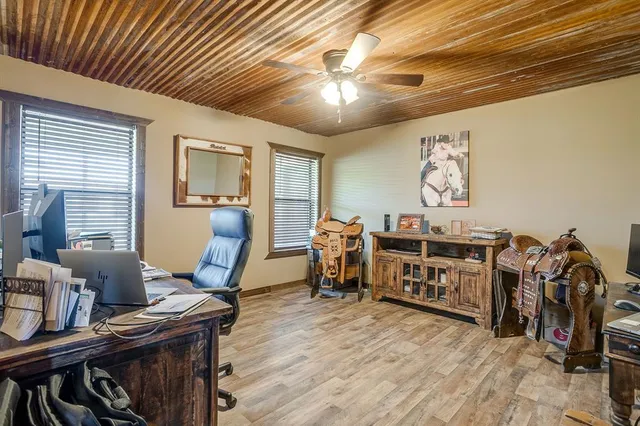 a view of a workspace with furniture and wooden floor