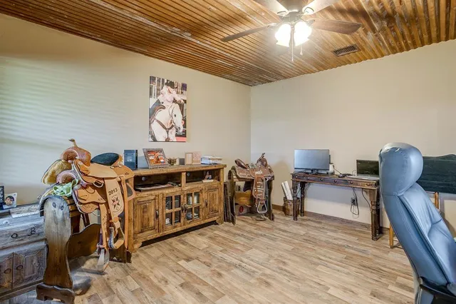 a view of a room with furniture and wooden floor