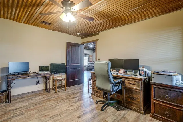 a view of a workspace with furniture and a workspace