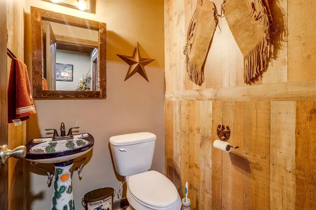a bathroom with a sink and mirror with toilet