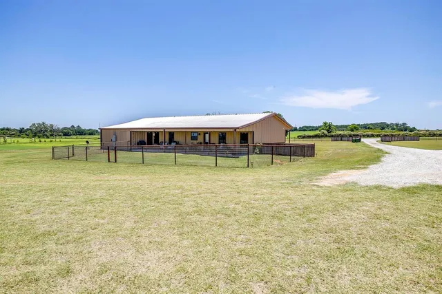 a view of a house with swimming pool and a yard