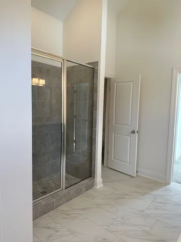 a bathroom with a glass shower door