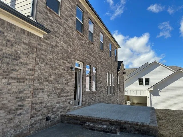 a view of a white house next to a yard