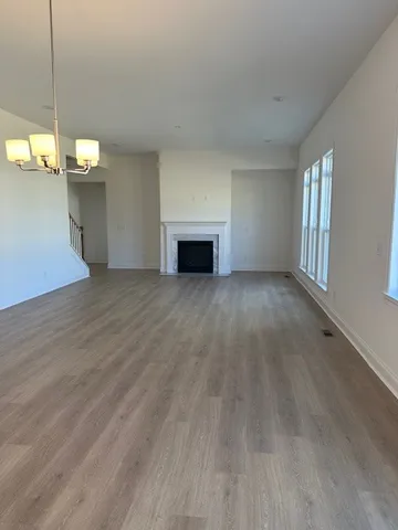 a view of a livingroom with a fireplace and window